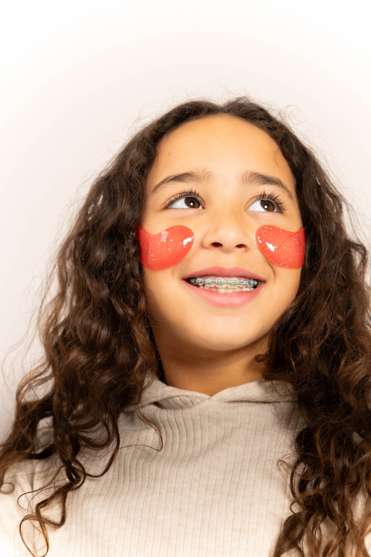 Smiling tween wearing heart-shaped skincare patches