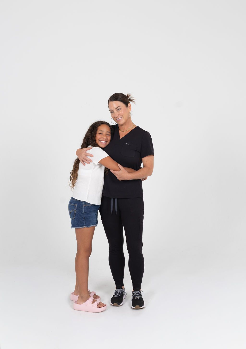 Esthetician mom hugging a tween girl